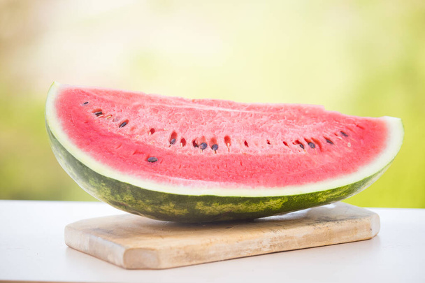 Fresh watermelon slice on blue wooden  background. Summer background - Фото, изображение