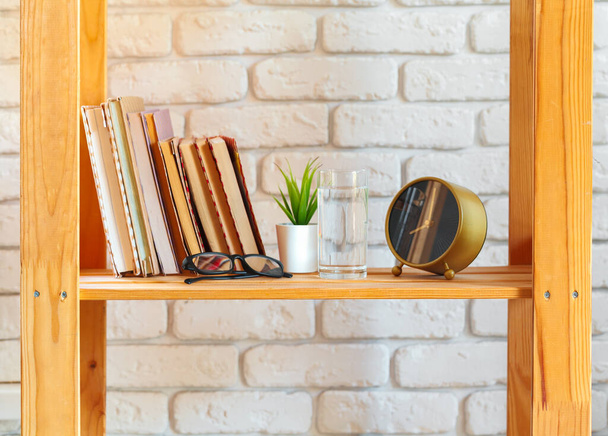 Wooden rack shelf with home decor stuff - 写真・画像