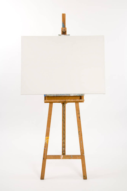 Well used artists easel with blank canvas waiting - Foto, afbeelding