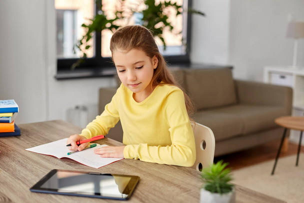 student girl writing to notebook at home - Foto, Imagen
