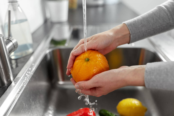 woman washing fruits and vegetables in kitchen - Photo, image