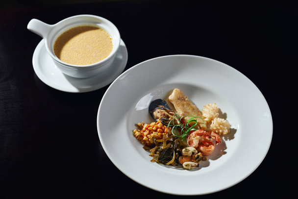Plate of seafood and sauce on table. - Photo, Image