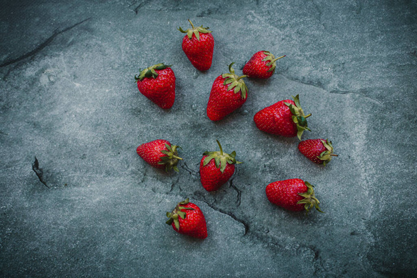 strawberry lies on a gray background - Фото, зображення