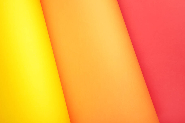 Color papers flat composition background with yellow, orange and red color with copy space. Top view - Zdjęcie, obraz