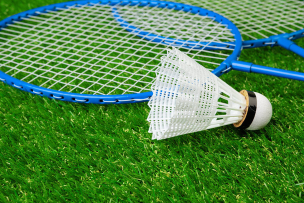 Badminton game rackets and shuttlecock on grass - Photo, image