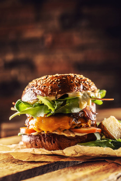 Home made tasty burger with bacon onion cheese ane lettuce on wooden box - Valokuva, kuva
