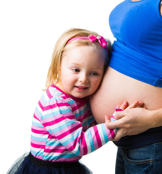 Pregnant woman with 2 yo daughter on white - Valokuva, kuva