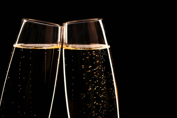 Two glasses of champagne on black stylish background. Place for text. Festive concept. - Foto, immagini