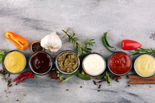Sauces Assortment. Set of various sauces in bowls with ketchup, mayonnaise, pesto and mustard - Foto, afbeelding