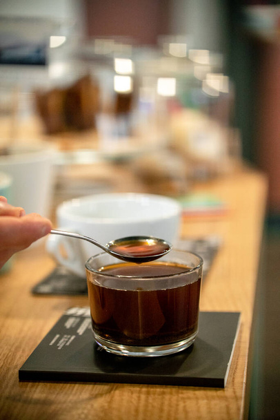 Black filter coffee on the table in cafe glass cup hario pour over cup side view - Photo, image
