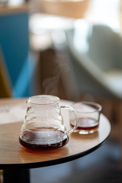 Black filter coffee on the table in cafe service kettle hario pour over cup side view - Foto, Imagem