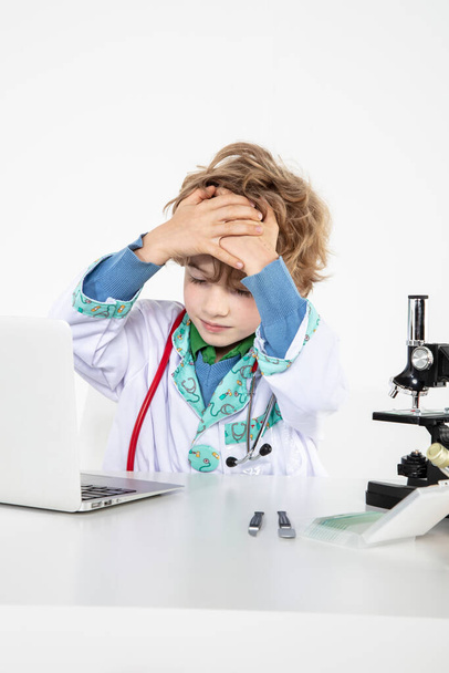 young doctor sitting over a microscope in his laboratory - Foto, immagini