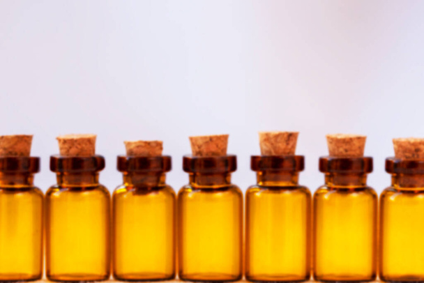 Defocused photo of amber-colored pharmaceutical vials. Copy space - Foto, Imagem