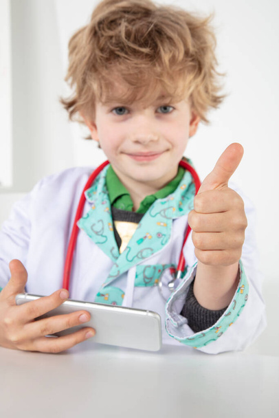 busy young doctor shows thumbs up, a symbol of good luck - Valokuva, kuva