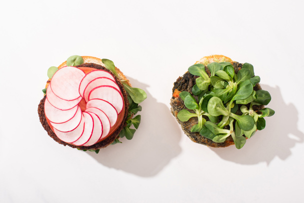 top view of vegan burgers with microgreens, radish on white background - Photo, Image