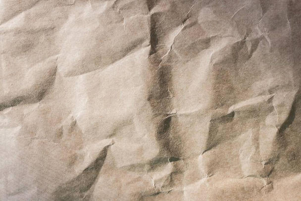 Rough paper, wrinkled texture. Light, beige tones, no pattern. Organic, natural materials. Side lighting. - Photo, Image