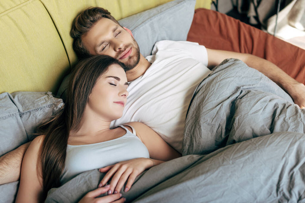 happy man and attractive woman sleeping in bed  - Photo, image