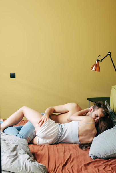 passionate man touching sexy woman in bedroom  - Φωτογραφία, εικόνα