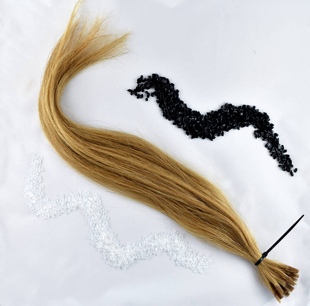 strand of blond hair on a white background - Photo, Image