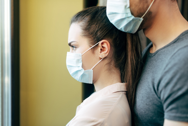 selective focus of woman and man in medical masks  - Foto, Bild