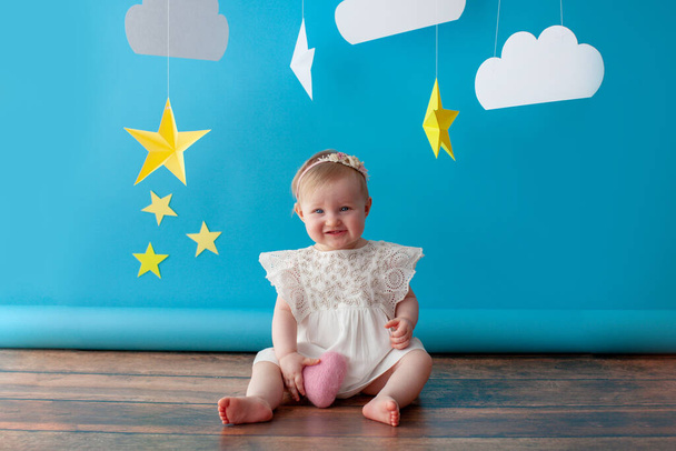 First baby birthday. Girl touches a star. - Фото, изображение