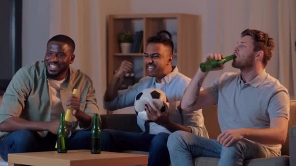 friends with ball and vuvuzela watching soccer - Záběry, video