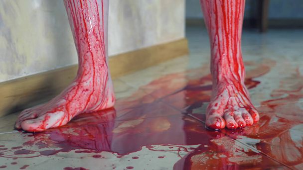 the bloody traces of blood from bare feet on the floor - Foto, Imagen