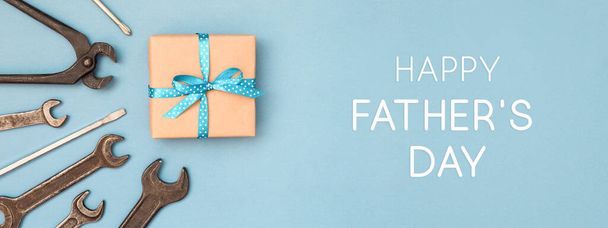 Happy Fathers day card with gift box and wrench. - Foto, imagen
