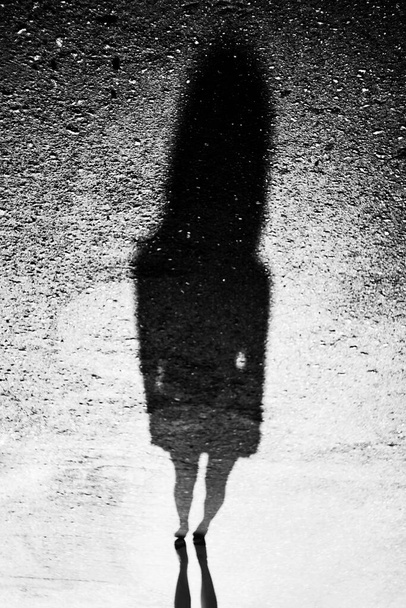 Mystic female shadow. Abstract black and white photo. Strange woman silhouette - 写真・画像
