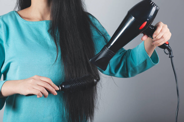 Woman Hair styling with a hair dryer - Fotografie, Obrázek