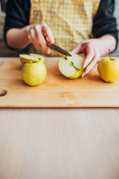 Woman housewife peels apples for juicer - cooking freshly squeezed apple juice - 写真・画像