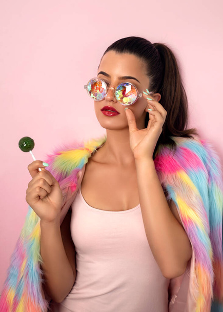 Young woman posing with lollipop studio shot  - Zdjęcie, obraz