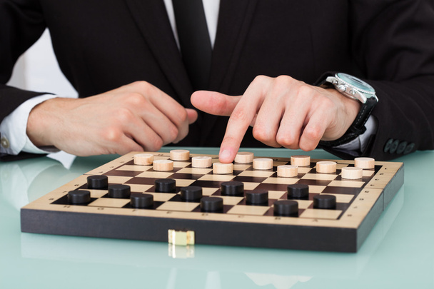 Businessman Playing Checkers - Foto, Bild