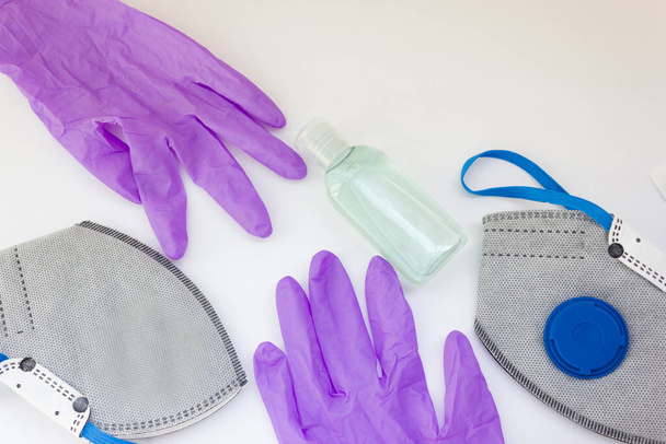 Coronavirus personal protective equipment concept with copy space. Medical latex gloves, goggles, ffp2 respirator, antibacterial gel.coronavirus flatly. - Photo, Image