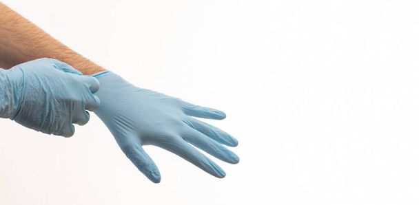 Doctor hands with surgical gloves isolated on white background. Medical staff protective gear against coronavirus COVID 19. Health care, hospital safety concept - Photo, Image