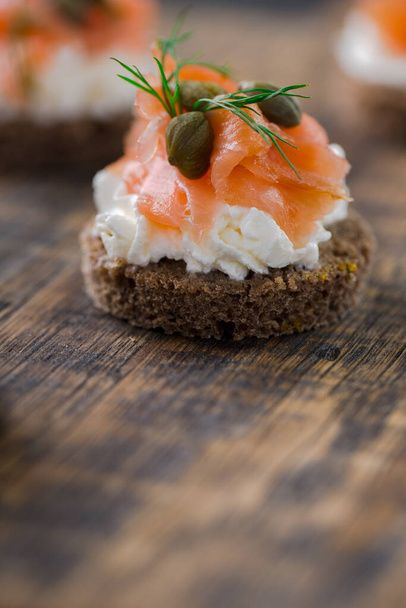 mini sandwiches with cream cheese, smoked salmon, capers and dill - Photo, Image