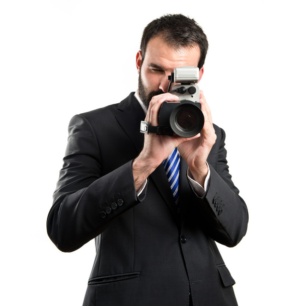 Young businessman recording video over white background - Фото, зображення