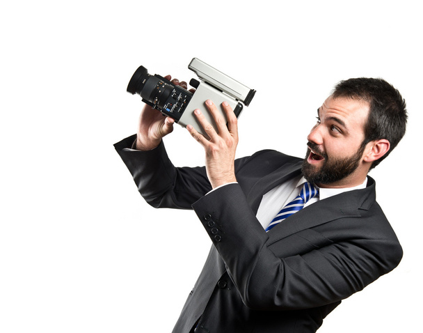 Young businessman recording video over white background - Photo, image