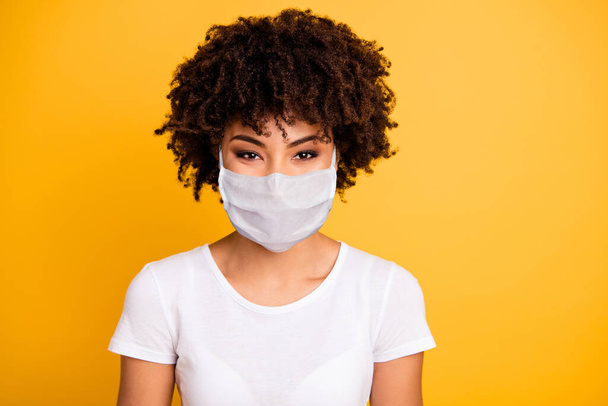 Close up photo beautiful amazing she her dark skin lady optimistic save covid-19 infection wear medical mask casual white t-shirt isolated yellow bright vibrant vivid background - Fotó, kép
