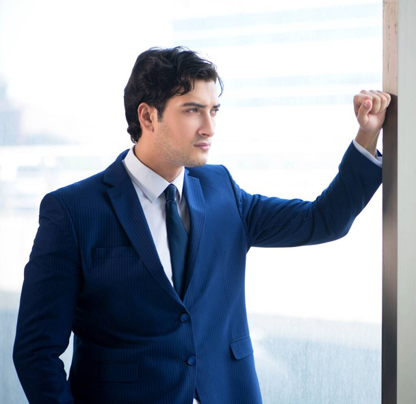 Young handsome businessman standing at the window - Valokuva, kuva