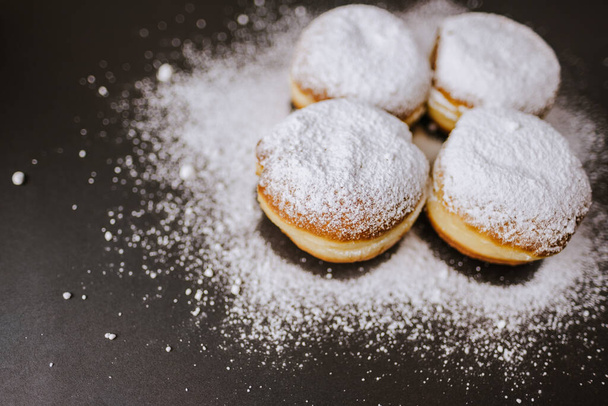 Donuts sprinkled with powdered sugar. - Fotó, kép