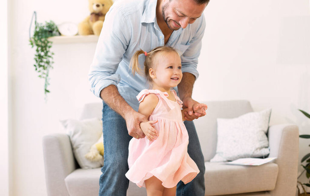 Caucasian father playing with his cute loving daughter - Photo, Image