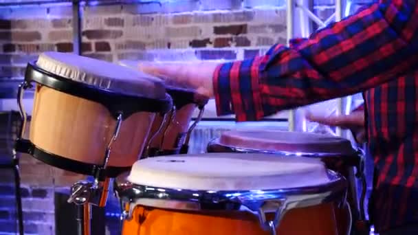 Musician vigorously plays percussion with palms of his hands. - Footage, Video