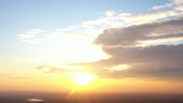 sunset aerial panorama with the beautiful clouds illuminated by the red sun beams - Footage, Video