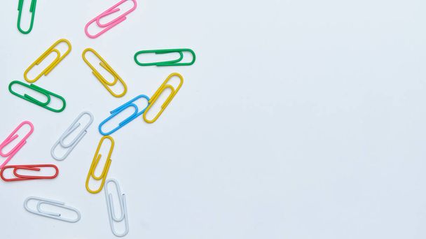 Multi-colored paper clips on a white background. Top view. Close up. Copy space. - Φωτογραφία, εικόνα