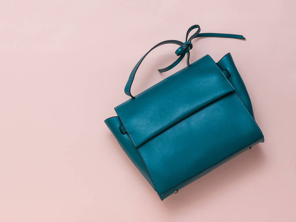 Bag made of dark turquoise leather on a pastel background. The view from the top. - Photo, Image