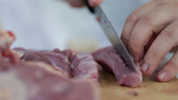 Cutting meat on wooden board - Footage, Video