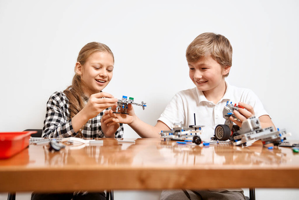 Young friends having fun, using building kit. - Photo, image