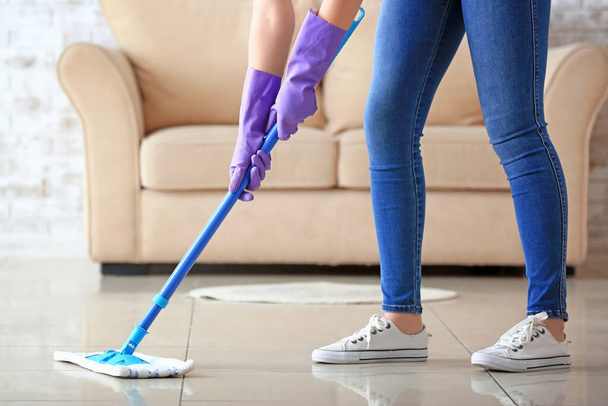 Woman mopping floor in room - Zdjęcie, obraz