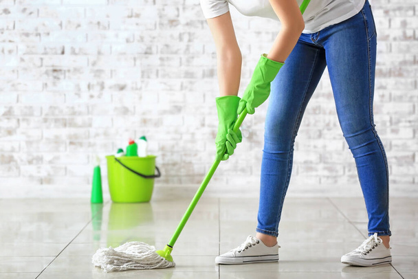 Woman mopping floor in room - Foto, imagen